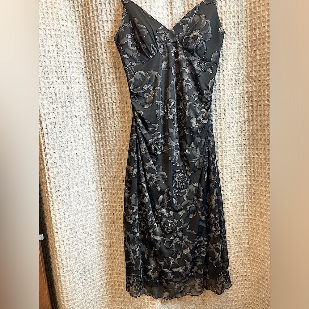Stunning black dress with accented with silver trimmed flowers.